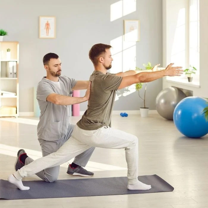 A Pro Motion Calgary practitioner coaching a client through a rehabilitation exercise