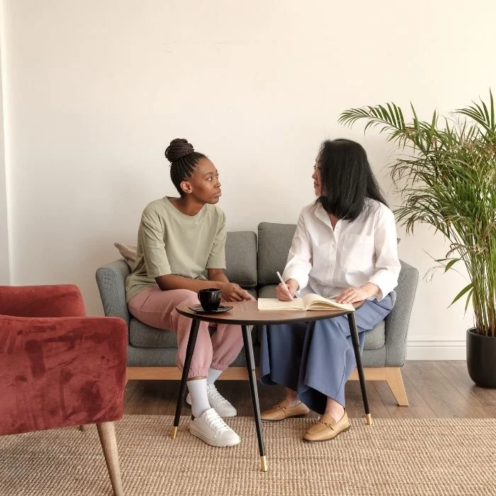 Counselor and patient having open conversation during therapy session focused on emotional wellbeing and personal growth